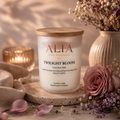 A floral scented cocosoy candle in a frosted glass jar with bamboo lid