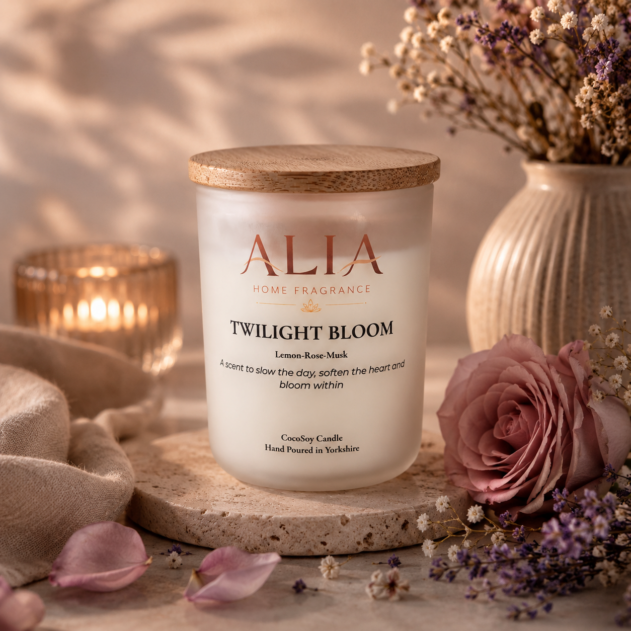 A floral scented cocosoy candle in a frosted glass jar with bamboo lid