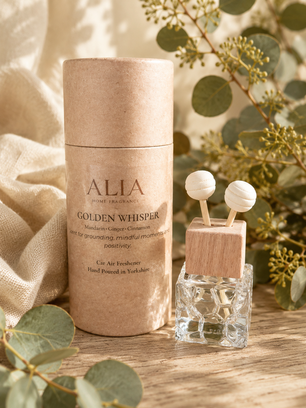 Golden Whisper Vent Clip Car Air Freshener featuring citrus, orchard fruit and warming spice notes, designed to fragrance vehicles through airflow from car vents.