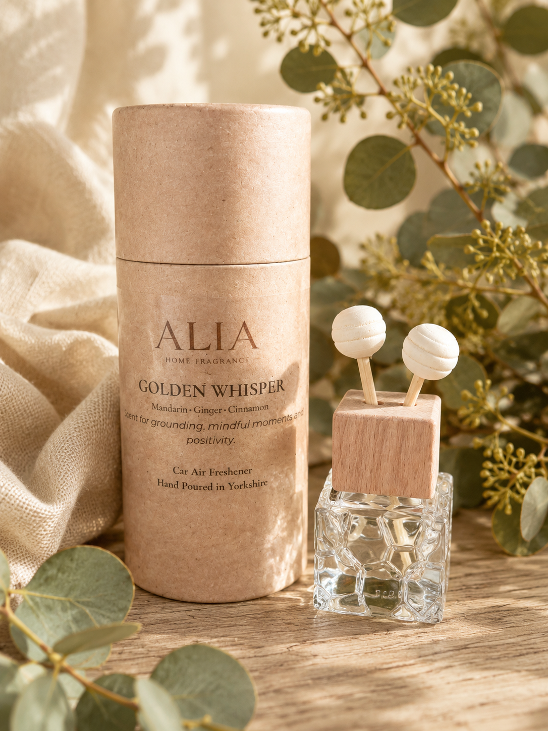Golden Whisper Vent Clip Car Air Freshener featuring citrus, orchard fruit and warming spice notes, designed to fragrance vehicles through airflow from car vents.